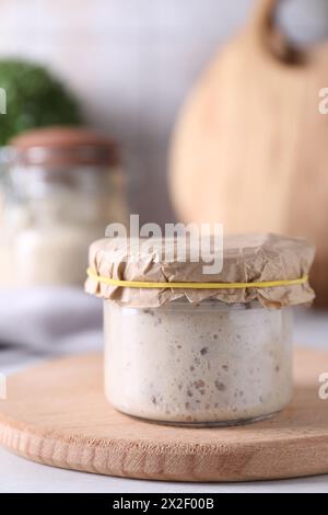 Sourdough starter in glass jar on table Stock Photo