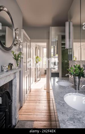 Silver mirror above marble fireplace in ensuite bathroom of Georgian townhouse in Paultons Square, Chelsea, London, UK. Stock Photo