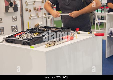 Master demonstrates equipment for installing heating pipes and underfloor heating. Industry Stock Photo