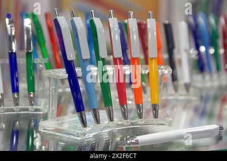 Modern colored plastic ballpoint pens on store display Stock Photo