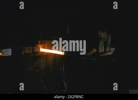 STEN GUN PRODUCTION IN BRITAIN, 1943 - The billet being drawn from the furnace at the steel mill before being rolled into rods from which Sten gun extractions will be made Stock Photo