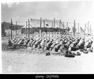 Italian prisoners of war are shown at prayer during a visit to their ...