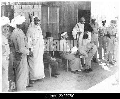 VISIT TO ITALIAN PRISONER OF WAR CAMP - Prisoner kissing the hands of Sayed Idris British Army Stock Photo