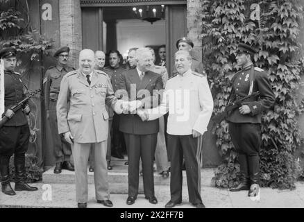 THE POTSDAM CONFERENCE, JULY-AUGUST 1945 - Winston Churchill, President Harry Truman and Joseph Stalin shake hands after the meeting during the conference, 23 July 1945.Code-named TERMINAL this was the final Big Three meeting of the war Churchill, Winston Leonard Spencer, Truman, Harry S, Stalin, Joseph Stock Photo