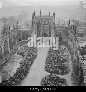 COVENTRY, ENGLAND, SPRING 1944 - This aerial photograph, looking down into the hollow, roofless shell of Coventry Cathedral, was taken from the West tower and shows how a path has been cleared through the rubble and debris along the central nave of the building. A cross of charred roof beams is just visible on the site of the high altar Stock Photo