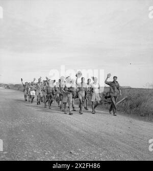 THE JAPANESE SURRENDER IN THAILAND, 1945 - A group of recently released British prisoners of war march toward an airfield in Thailand from where they will be flown by Royal Air Force Dakota aircraft to Mingladon airfield in Rangoon Stock Photo