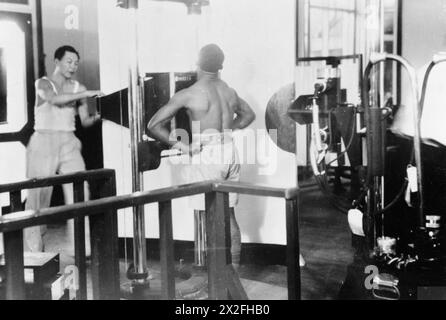 CARIBBEAN ARMED FORCES DURING THE SECOND WORLD WAR - At the military hospital for troops in the South Caribbean area based at Port of Spain, Trinidad, a soldier is seen undergoing a chest examination by a 35mm X-Ray machine. A black and white copy negative , Stock Photo