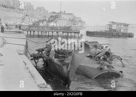 BLITZ ON MALTA. 1942, DAMAGE CAUSED AFTER A BLITZ ON MALTA, MOST BOMBED ISLAND IN THE WORLD. - All that remains of a tug which was hit by a bomb Stock Photo