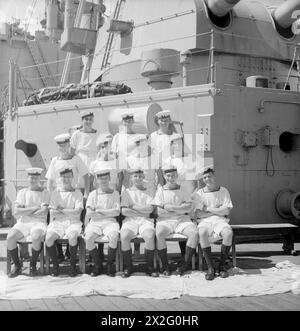MEN OF THE HMS SUFFOLK, A CRUISER SERVING WITH ADMIRAL JAMES SOMERVILLE'S EASTERN FLEET. 12 DECEMBER 1943, TRINCOMALEE. THE MEN ARE DIVIDED INTO GROUPS BY TOWN AND/OR DISTRICT. - East London group. Front row, left to right: AB C Brown; AB R Sidwell; Stoker W West; AB E Chamberlain; AB C Purton; L/Sea T McNally. Second row, left to right; AB E Challenger; AB W Tatman; AB F Stemp; AB S Tuff. Third row, left to right: AB A Meddings; O/Sea L Howard; AB W Legg Stock Photo