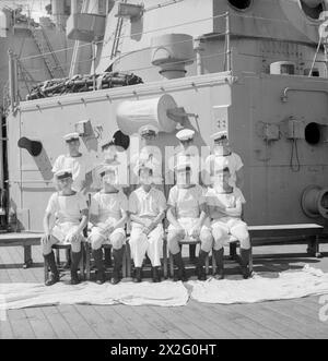 MEN OF THE HMS SUFFOLK, A CRUISER SERVING WITH ADMIRAL JAMES SOMERVILLE'S EASTERN FLEET. 12 DECEMBER 1943, TRINCOMALEE. THE MEN ARE DIVIDED INTO GROUPS BY TOWN AND/OR DISTRICT. - Colchester and District group. Front row, left to right; O/Sea D Scott, Colchester; AB J Clench, Wivenhoe; L/Ck Ramage, Colchester; AB Goldsmith, Mistley; L/Tel Felgate, Parkestone. Second row, left to right: AB Whittle, Lawford; O/Sea Denny, Halstead; Mne Rudgo, Dedham; AB Hodgesonn, Boxted; AB G Clark, Sible Hedingham Stock Photo