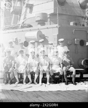 MEN OF THE HMS SUFFOLK, A CRUISER SERVING WITH ADMIRAL JAMES SOMERVILLE'S EASTERN FLEET. 12 DECEMBER 1943, TRINCOMALEE. THE MEN ARE DIVIDED INTO GROUPS BY TOWN AND/OR DISTRICT. - Kent and Sussex group. First row, left to right: Cpl G Knapper, Horsham; Blk Faires, Horsham; PO H Sears, ?; OM Parr, Horley; AB Rogers, Sevenoaks; Mne Callister, Tonbridge. Second row, left to right: A Clarke, Hastings; AB Bumpstead, Hastings; Boy Thornton, Tonbridge; Sig Moore, Worthing; AB Mankelow, Rusthall; Stoker Laurence, Tonbridge Stock Photo