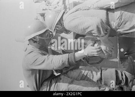 The gun crew operates a 3-inch naval gun on HMS Sunfish while the ...