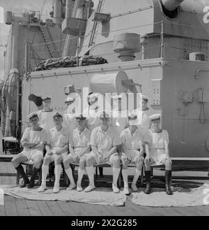 MEN OF THE HMS SUFFOLK, A CRUISER SERVING WITH ADMIRAL JAMES SOMERVILLE'S EASTERN FLEET. 12 DECEMBER 1943, TRINCOMALEE. THE MEN ARE DIVIDED INTO GROUPS BY TOWN AND/OR DISTRICT. - NW London group. Front row, left to right: L/Sig Scales; R/P O Burdes; PO Gibbs; R/PO Betty; OM Suckling; L/Sea Gummery. Second row, left to right: AB Phipps; AB Marlow; AB Bond; AB Hall; AB Kennedy Stock Photo