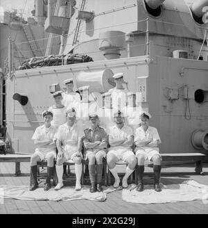 MEN OF THE HMS SUFFOLK, A CRUISER SERVING WITH ADMIRAL JAMES SOMERVILLE'S EASTERN FLEET. 12 DECEMBER 1943, TRINCOMALEE. THE MEN ARE DIVIDED INTO GROUPS BY TOWN AND/OR DISTRICT. - Medway Towns group. Front row, left to right: CA R Fever, Gillingham; ERA Desmares, Gillingham; C Sergeant Kempt, RM, Gillingham; PO W Reddick, Old Brompton; Jnr W Stannard, Rainham. Second row, left to right: AB Cross, Chatham; Stoker Vant, Gillingham; Stoker Warrener, Aylesford; L/Stoker Grieve, Gillingham. Third row, left to right: L/Stoker Pearson, Strood; Stoker Fielder, Gillingham Stock Photo