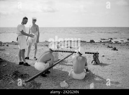 Gunney Shell HMS Newcastle, an Eastern Fleet cruiser, calibrates her guns near ...
