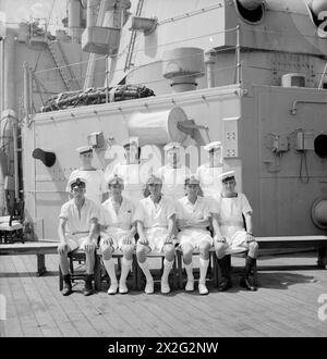 MEN OF THE HMS SUFFOLK, A CRUISER SERVING WITH ADMIRAL JAMES SOMERVILLE'S EASTERN FLEET. 12 DECEMBER 1943, TRINCOMALEE. THE MEN ARE DIVIDED INTO GROUPS BY TOWN AND/OR DISTRICT. - Ilford and District group. Front row, left to right: PO R Ward, Hainault; M A A R Steward, Ilford; CPO Churches, Seven Kings; Yeo Sigs G Geary, Ilford; AB Cambleton, Ilford. Second row, left to right: L/Sea Ackfield, Barkingside; L/Wmn Ball, Barking; AB Kingston, Chadwell Heath; AB Sampson, Newbury Park Stock Photo