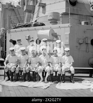 MEN OF THE HMS SUFFOLK, A CRUISER SERVING WITH ADMIRAL JAMES SOMERVILLE'S EASTERN FLEET. 12 DECEMBER 1943, TRINCOMALEE. THE MEN ARE DIVIDED INTO GROUPS BY TOWN AND/OR DISTRICT. - Lincolnshire group. Front row, left to right: L/Sea D Clay; AB J Greenwood; AB F Trott; Stoker A Hather. Second row, left to right: Stoker J Hammond; Stoker A Beet; Stoker W Wright; Shpt D Miller; AB W Evans; AB N Fowler Stock Photo