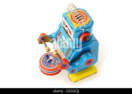 Old vintage tin robot with drum and sticks on white background Stock Photo