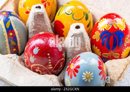 Colourful Hand painted easter eggs in an egg box Stock Photo