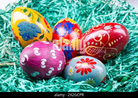 Colourful Hand painted easter eggs in a fake nest Stock Photo