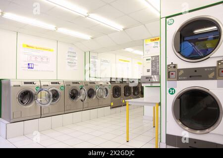 number of washing machines in empty public laundry, clean and light Stock Photo