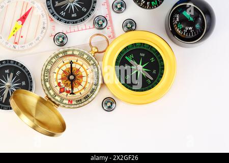 group of twelve different small and big compasses on white background Stock Photo