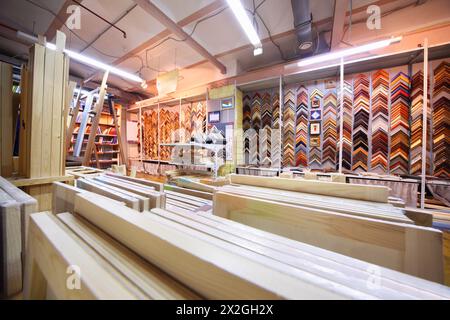 on shelves many canvases on stretchers for artists and samples of wooden frames in large store Stock Photo