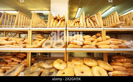 lots of fresh crisp loaves of bread on shelves in store; bread is one of main food Stock Photo