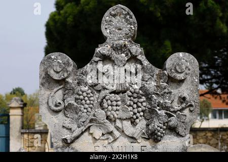 In Robion, Provence, France, the old cemetery contains tombs adorned with sculpted motifs depicting professions |  sculpture of grapes Stock Photo