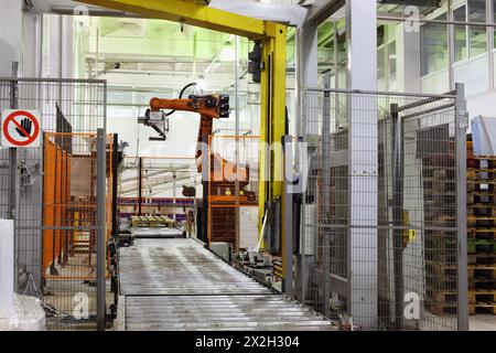 Machines and conveyor for packaging milk bottles at large milk factory Stock Photo