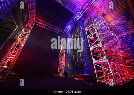 Colorful illuminated way with grid to boxing ring inside fight club; many lights Stock Photo