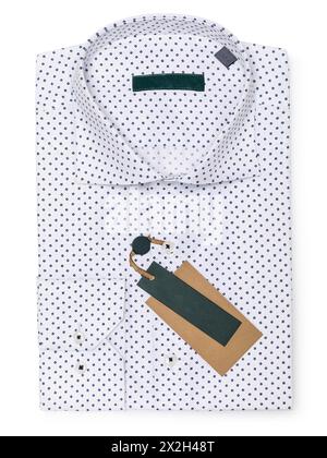 White folded polka dot shirt in dark blue color isolated on white background, top view Stock Photo