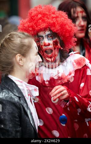 MOSCOW - MAY 14: Unidentified participants - red-haired curly dreadful clown and laughing made-up girl - at Zombie Parade on Old Arbat, May 14, 2011, Stock Photo