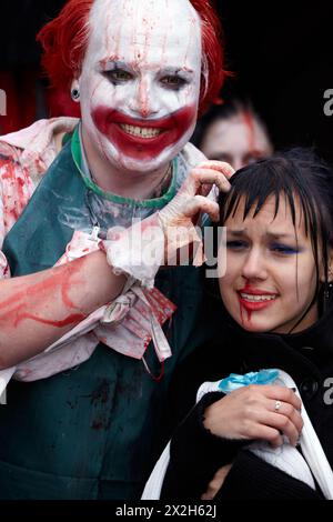 MOSCOW - MAY 14: Unidentified made-up participants - red-haired grinning clown with bloody face and crying girl - at Zombie Parade on Old Arbat, May 1 Stock Photo