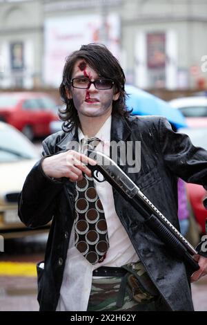 MOSCOW - MAY 14: Unidentified made-up participant of Zombie Parade on Old Arbat with shotgun in his hands, May 14, 2011, Moscow, Russia. Stock Photo