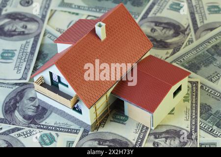 Two-story toy house with on hundred dollar notes. Stock Photo