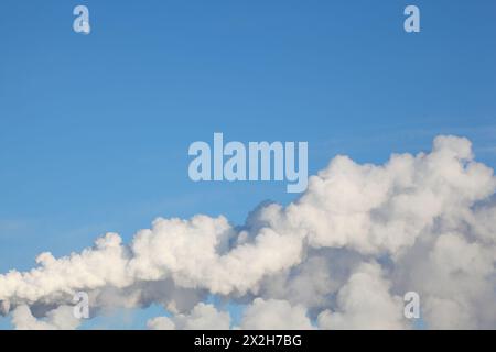 White moon. white clouds and white smoke from the heat electropower station on the morning blue sky Stock Photo