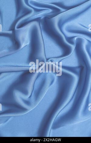 Blue silk or satin luxury fabric texture. Top view. Stock Photo
