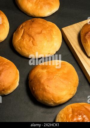 Fresh baked round bun isolated,Round buns on a balck and wooden background. Stock Photo