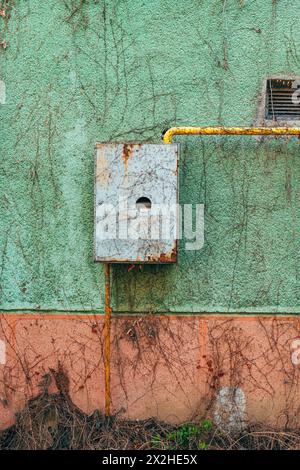 Old used gas meter on house external wall, copy space included Stock Photo