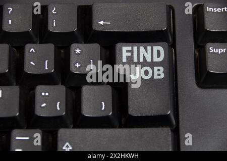Closeup of a highlighted key on the keyboard of a laptop showing the word "find job" Stock Photo