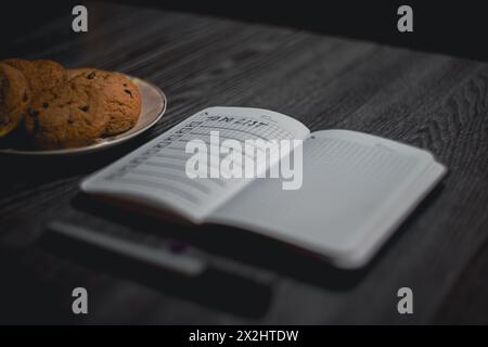 Notepad with a list of plans and a plate of cookies. High quality photo Stock Photo