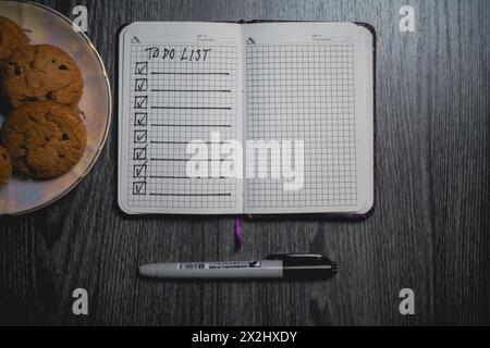 Notepad with a list of plans and a plate of cookies. High quality photo Stock Photo