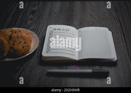 Notepad with a list of plans and a plate of cookies. High quality photo Stock Photo