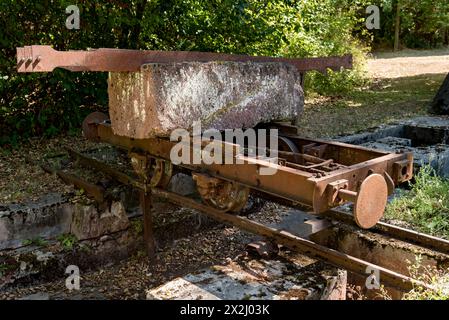 Rusty wagon, wagon on rail with block of Michelnau tuff, red basalt, red lava, slag agglomerate, disused Michelnau quarry, Tertiary volcano, geotope Stock Photo