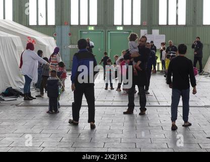 Children of refugees playing between tents in an emergency shelter for refugees on 9 December 2015 in the former hangar of Tempelhof Airport, Berlin Stock Photo