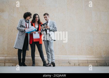 Business professionals discussing over documents against a textured backdrop Stock Photo
