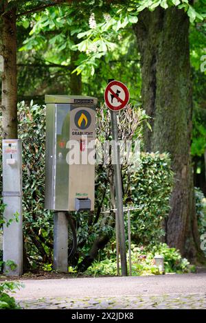 cologne germany april 22 2014: Vending machine for grave candles and a no dogs sign at the entrance to a cemetery in Cologne Stock Photo
