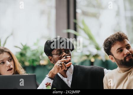 A multicultural group of people collaborate over a business meeting in a relaxed restaurant atmosphere, discussing strategies and sharing ideas. Stock Photo