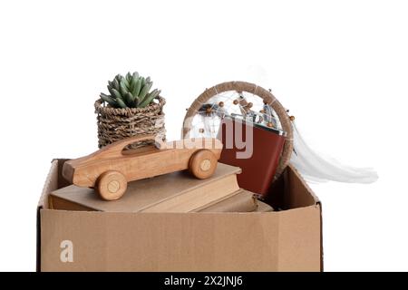 Box of unwanted stuff for garage sale on white background Stock Photo